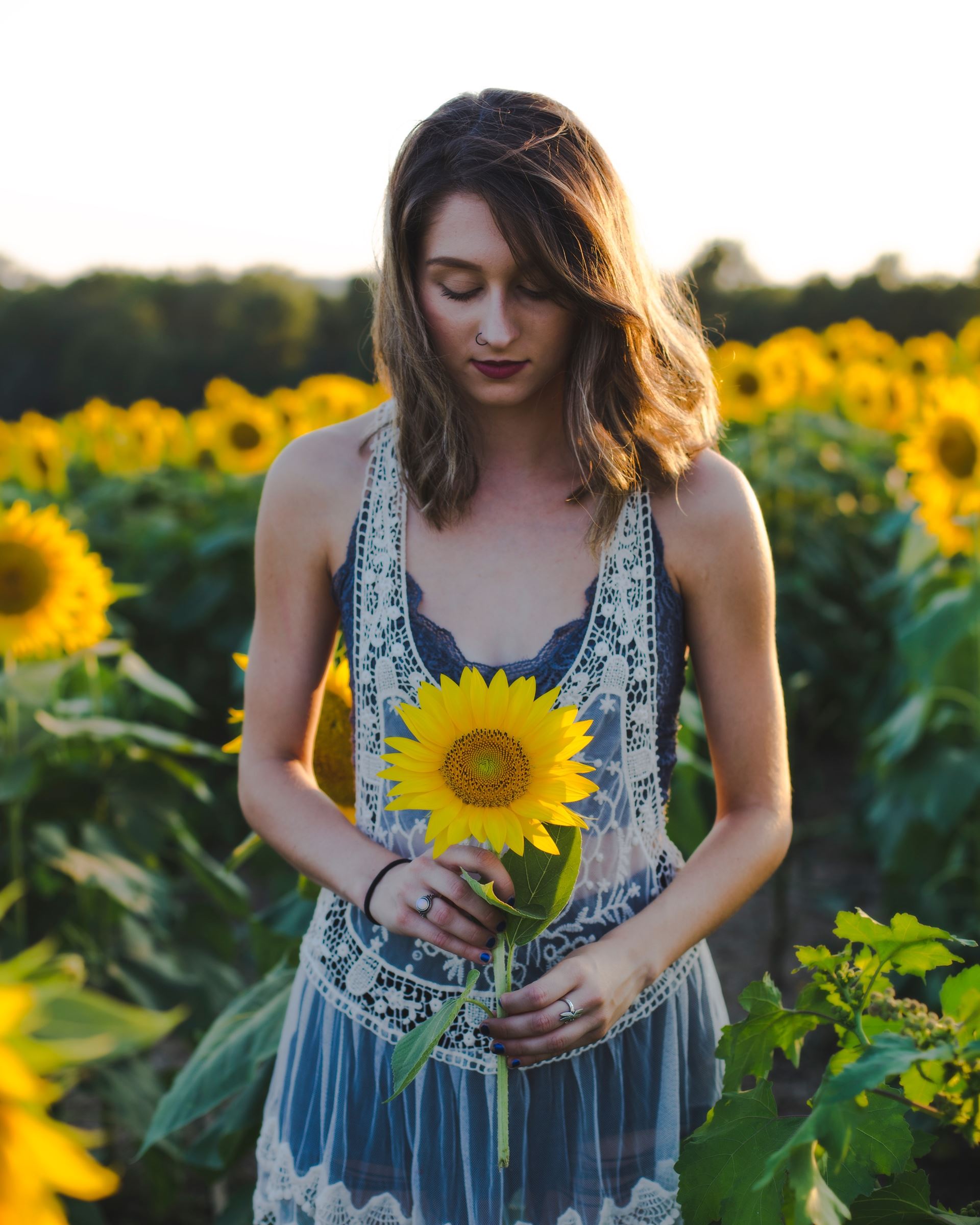 a young girl holding a flower